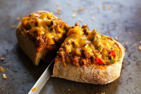 A piece of pizza bread sliced down the middle.