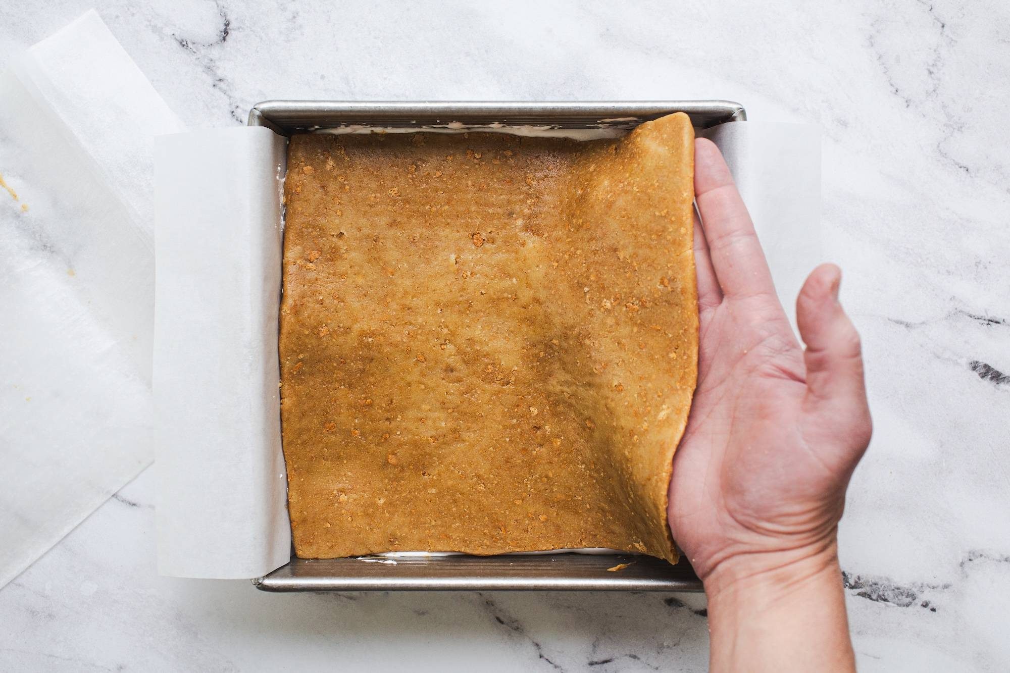 Placing top layer of cookie dough on top.