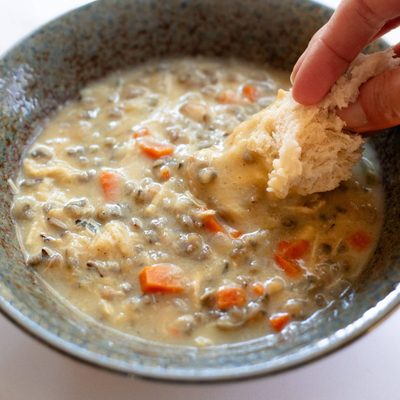 Crockpot Chicken Wild Rice Soup in a bowl with bread dip