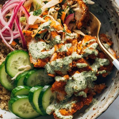 Chicken tikka bowls with a fork in the bowl square image