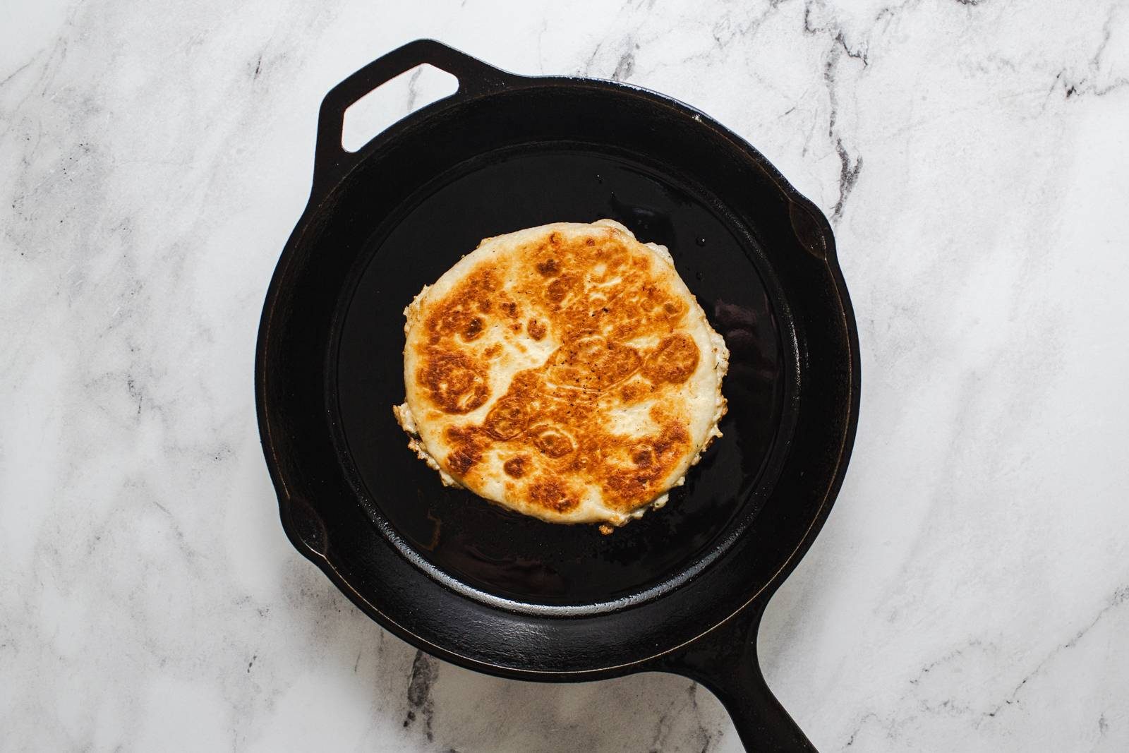 Frying smash tacos in a skillet.
