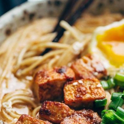 Homemade Spicy Ramen in a bowl with tofu and chopsticks.