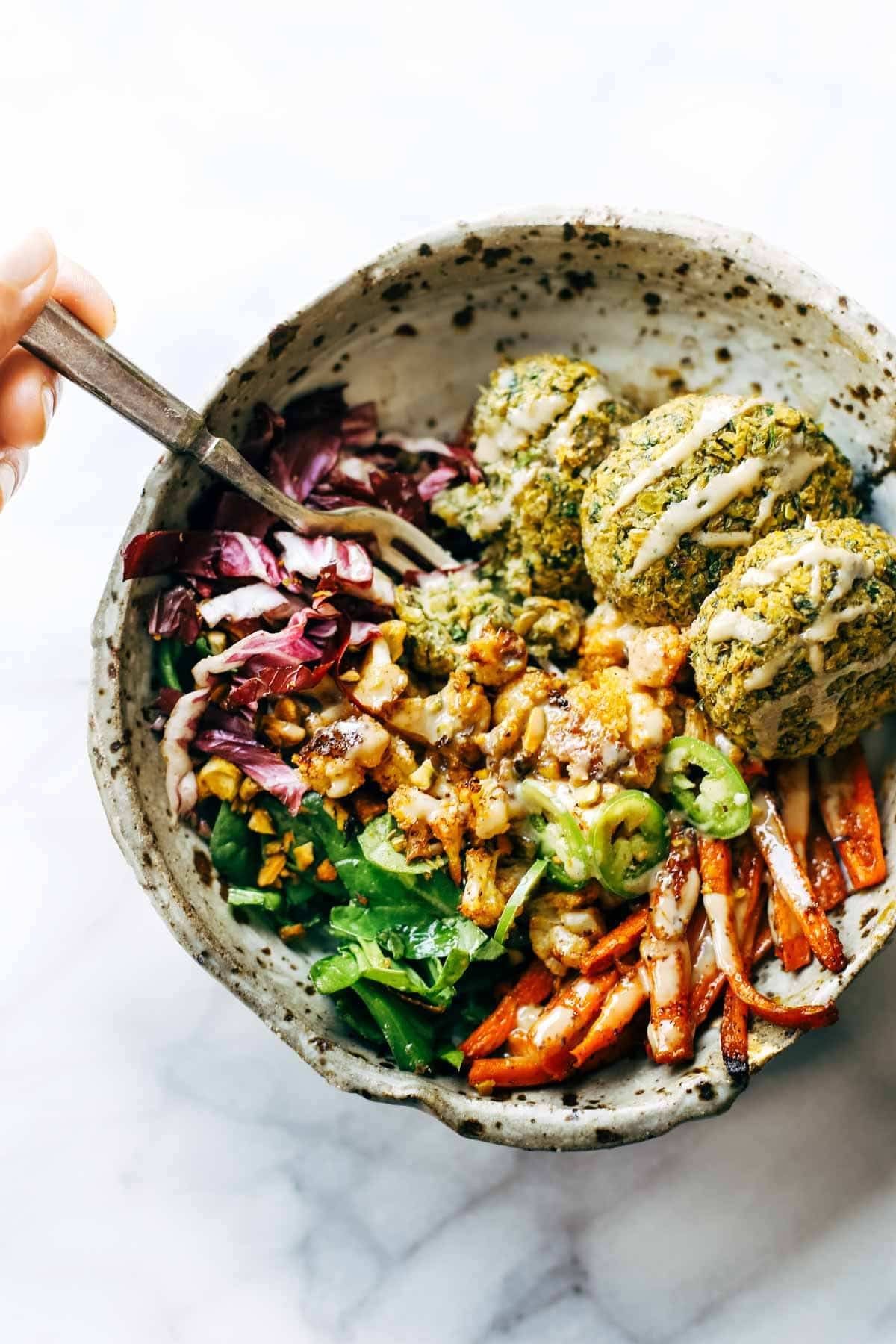 Keep your glow all winter! Easy homemade falafel, roasted veggies, and flavorful sauce all in one big bliss bowl! vegetarian / vegan / gluten free recipe. | pinchofyum.com Keep your glow all winter! Easy homemade falafel, roasted veggies, and flavorful sauce all in one big bliss bowl! vegetarian / vegan / gluten free recipe. | pinchofyum.com