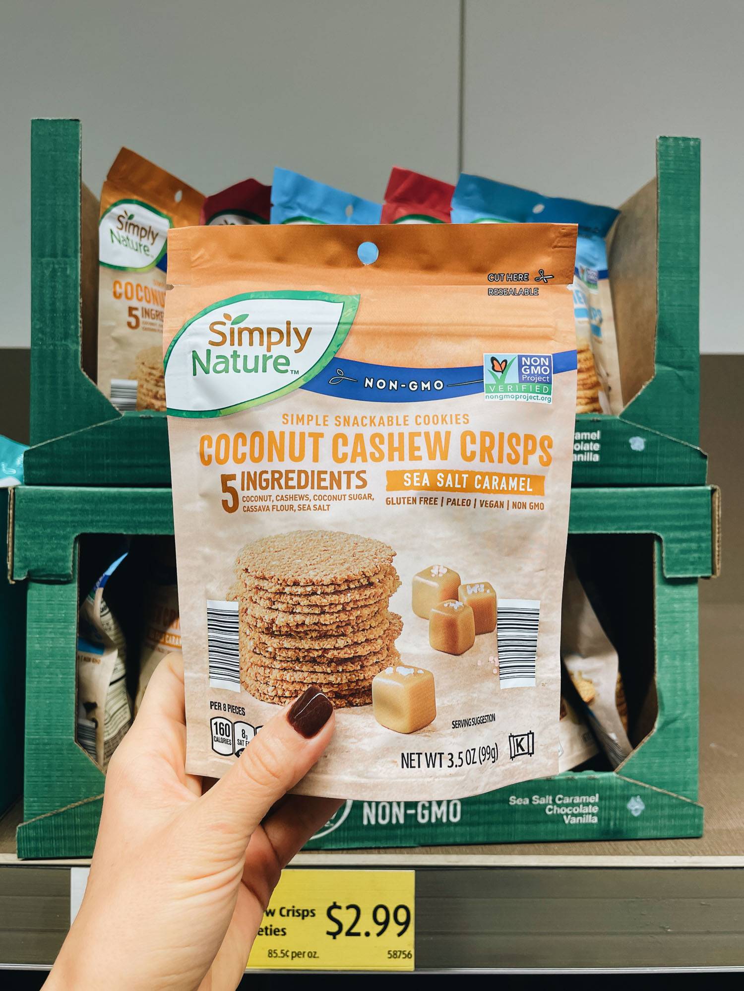 White hand holding bag of cookies