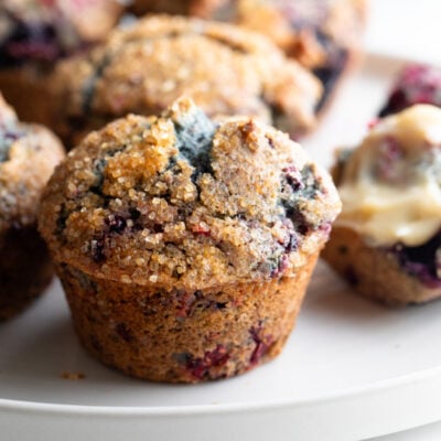 Mixed berry muffins on a plate.