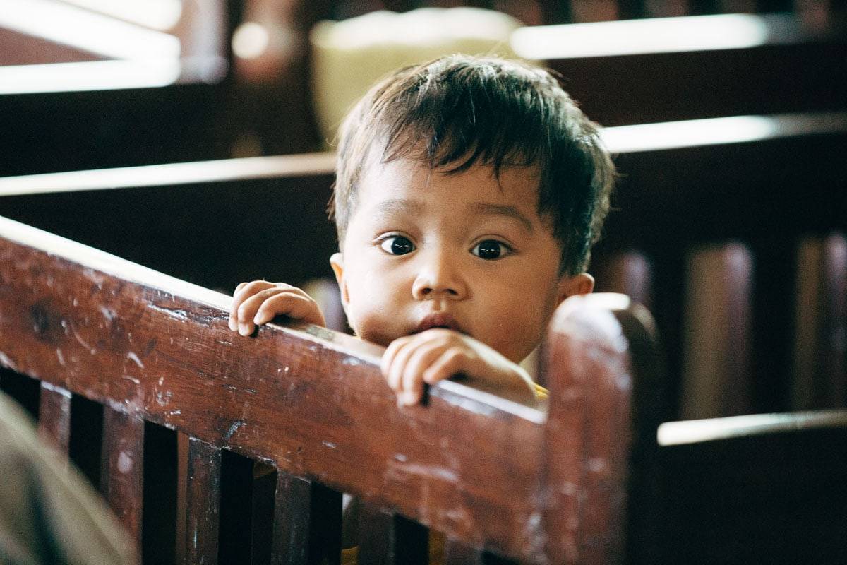 Little boy in a crib.