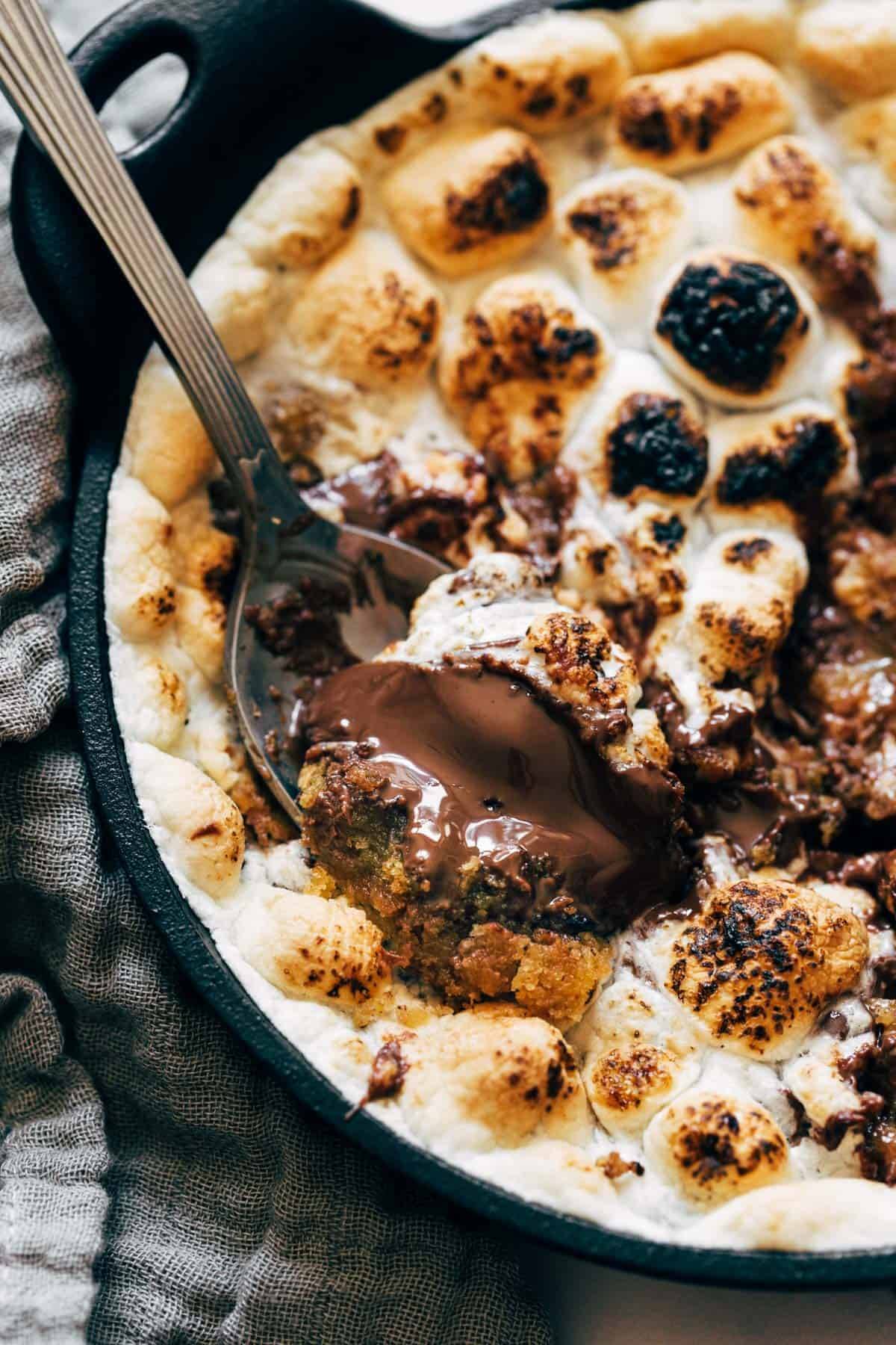 S'mores bowl with melted chocolate on spoon.