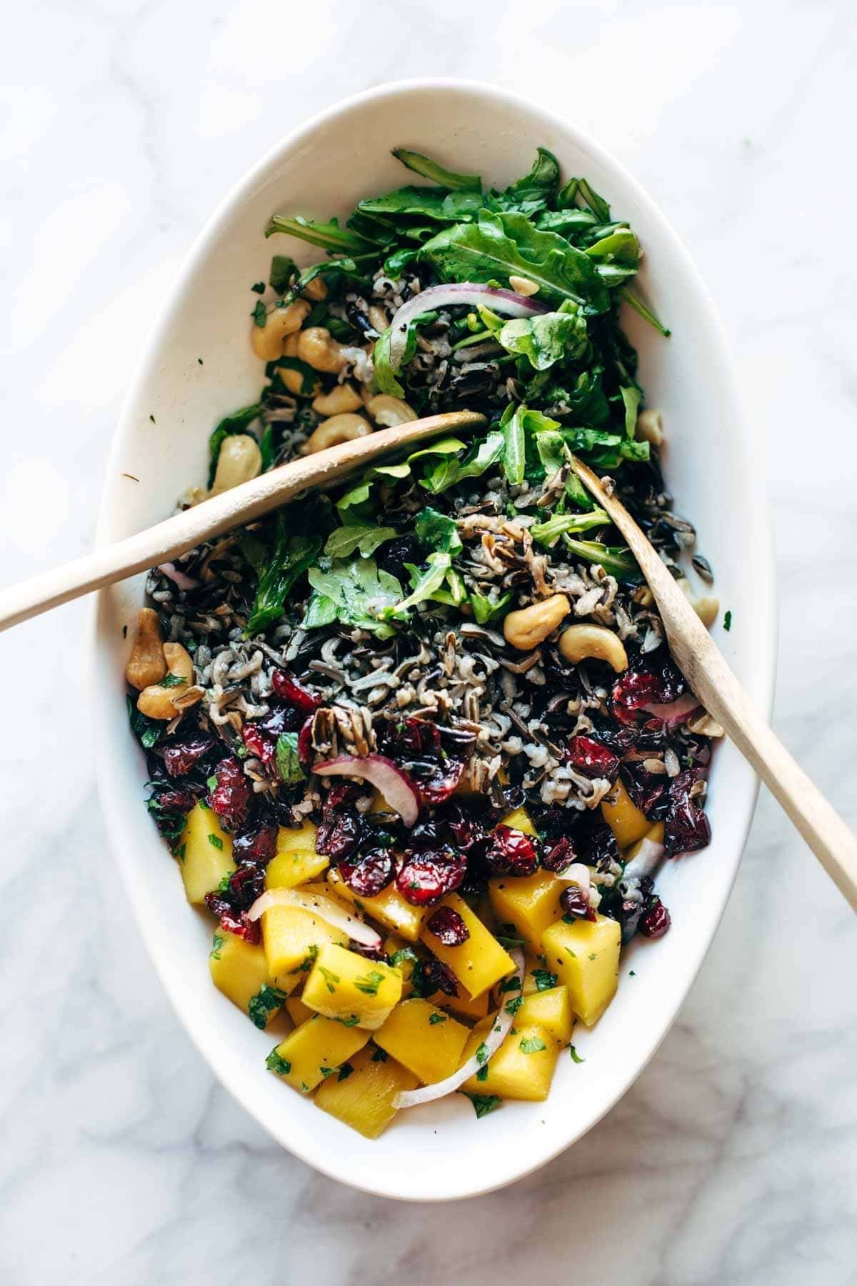 Easy Thanksgiving Salad - arugula, wild rice, cashews, dried cranberries, red onions, and a lemon dressing that shakes up easily in a jar. | pinchofyum.com Easy Thanksgiving Salad - arugula, wild rice, cashews, dried cranberries, red onions, and a lemon dressing that shakes up easily in a jar. | pinchofyum.com